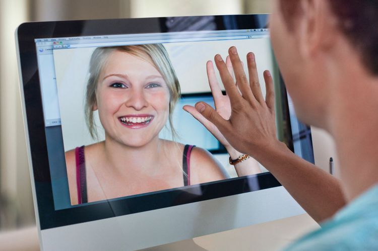 Man-touching-womans-hand-on-computer-screen