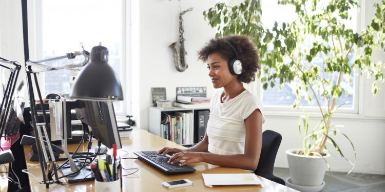 o-WOMAN-IN-HEADPHONES-IN-OFFICE-facebook