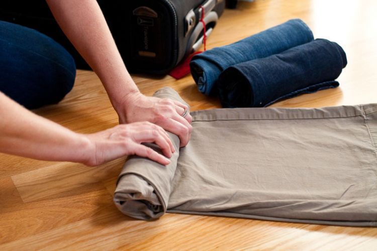 Flight attendant Heather Poole rolls pants as she demonstrates how to pack efficiently at her home in Los Angeles.