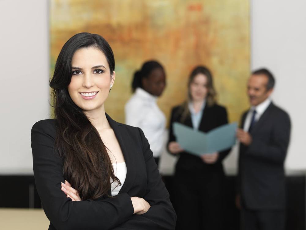 Confident-business-woman-with-her-team_iS-16547750