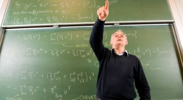 Professor teaching in front of blackboard --- Image by © Peter M. Fisher/Corbis