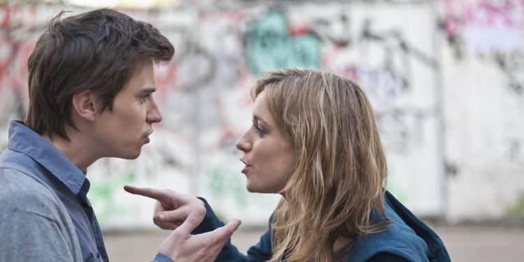 Young couple arguing in street