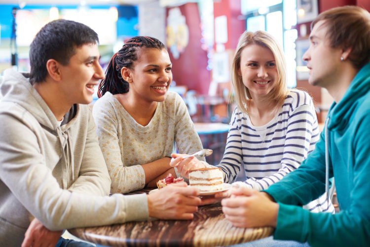 Image of teenage friends spending time in cafe