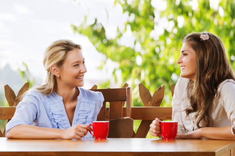 Two friends chatting with coffee