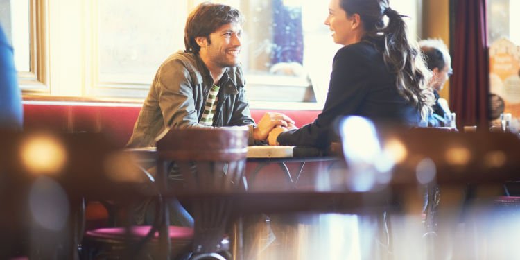 Couple holding hands in cafe bar