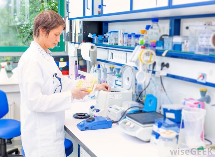 woman-in-lab-with-desk-and-equpiment