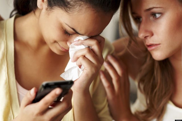 Young girl in sorrow with a friend consoling her