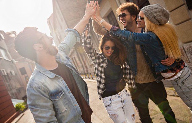 Friends joining hands outdoors