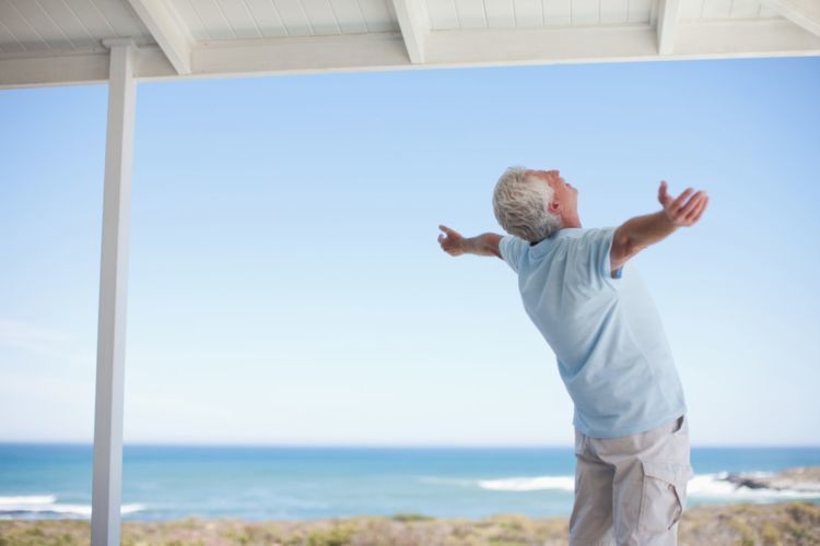 Senior man standing with arms outstretched