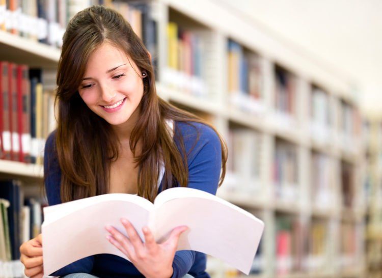 Woman reading a book at the library