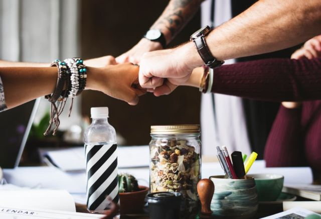 colleagues-cooperation-fist-bump-fists