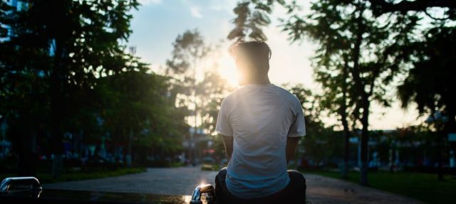 man-sitting-on-bench-during-sunset