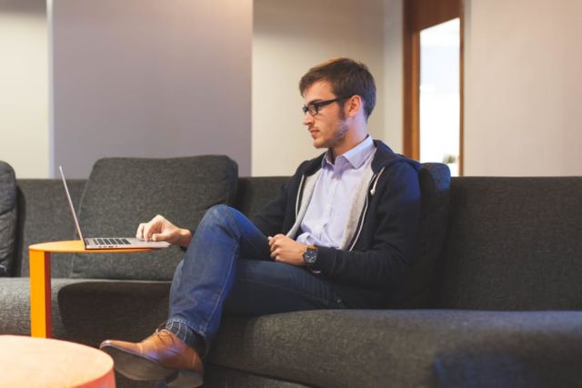 man-couch-working-laptop