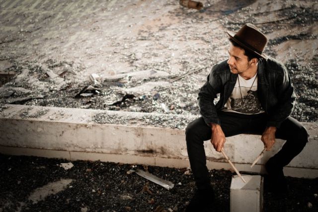 man-in-black-jacket-near-body-of-water-during-daylight