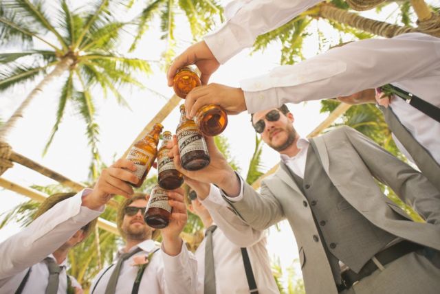 men-wearing-gray-formal-suit-holding-san-miguel-pale-pilsen-during-daytime