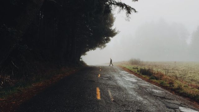 photograph-of-silhouette-of-man-crossing-the-road-during-daytime