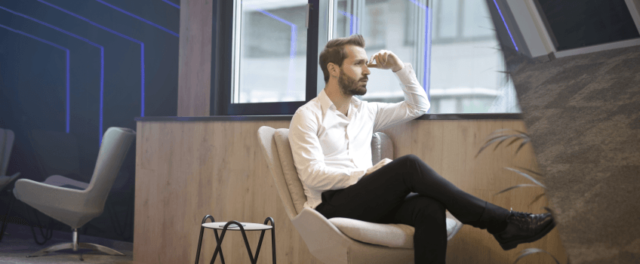 photo of a man sitting near the window