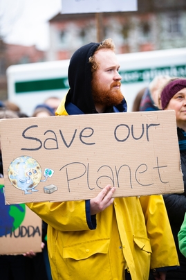 Person Holding Save Our Planet Sign