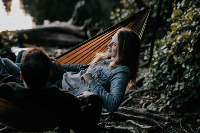 Man and woman liying in hammock