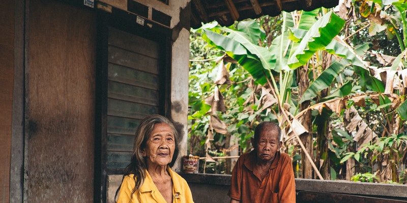 Women Wearing Yellow V-neck Shirt Sitting Beside Man