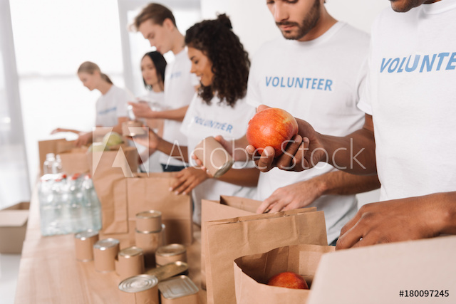 Volunteers Putting Food and Drinks Into Bags 