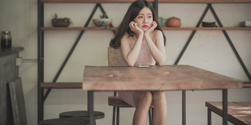 Photography of a woman sitting on the chair listening to